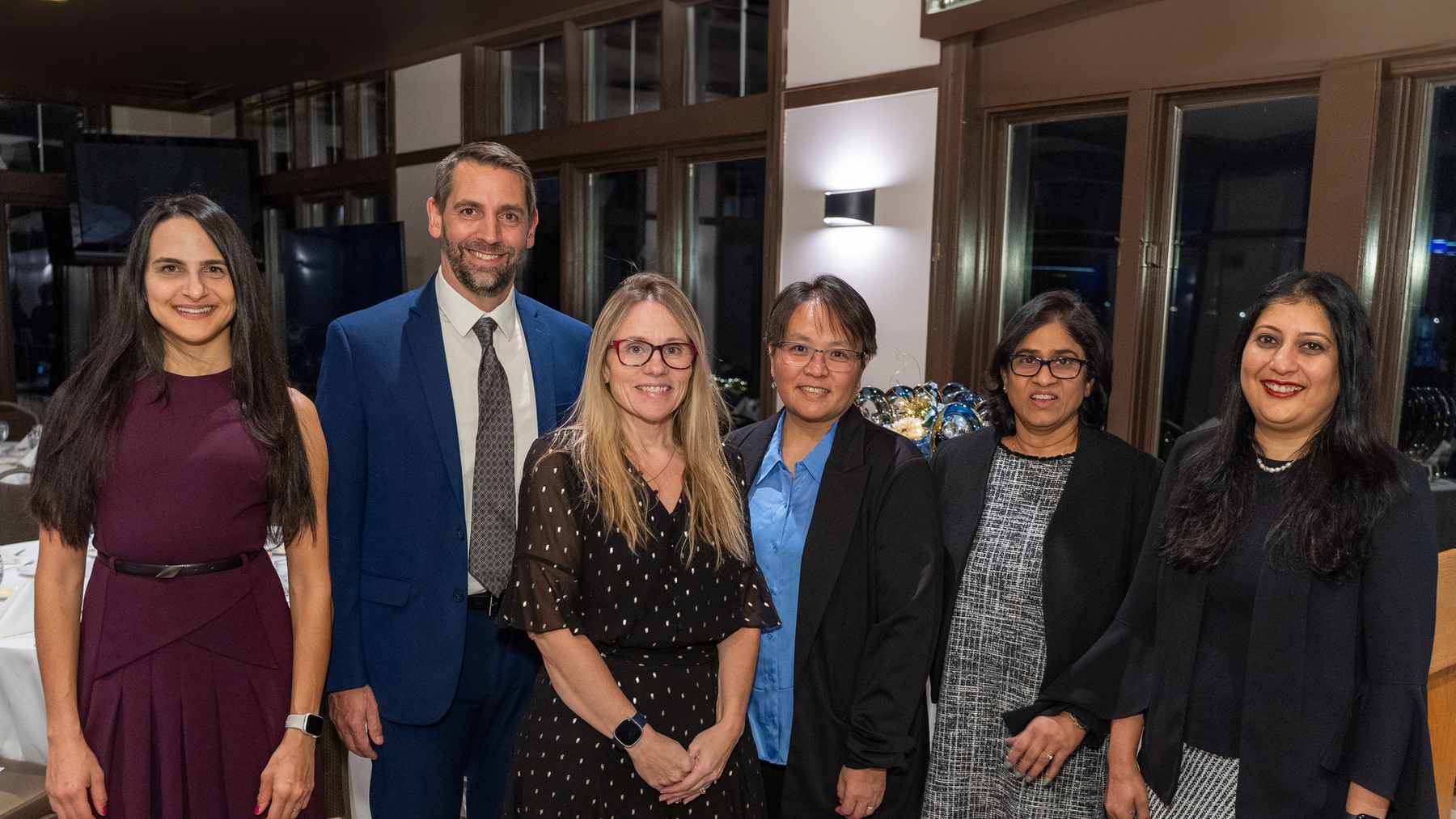 Six smiling AbbVie colleagues from the Ability employee resource group standing together at an event
