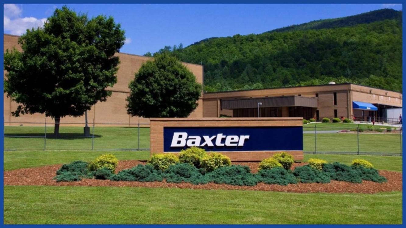 Baxter's North Cove plant in Marion, North Carolina, its sign set in a lawn below wooded mountains