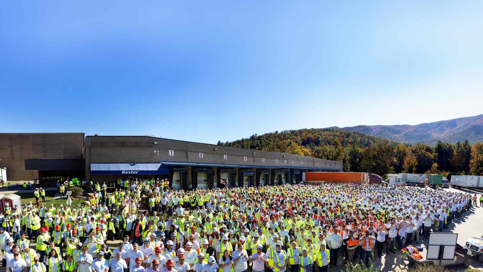 Hundreds of Baxter colleagues in safety vests and white coats gathered outside the North Cove plant in the mountains