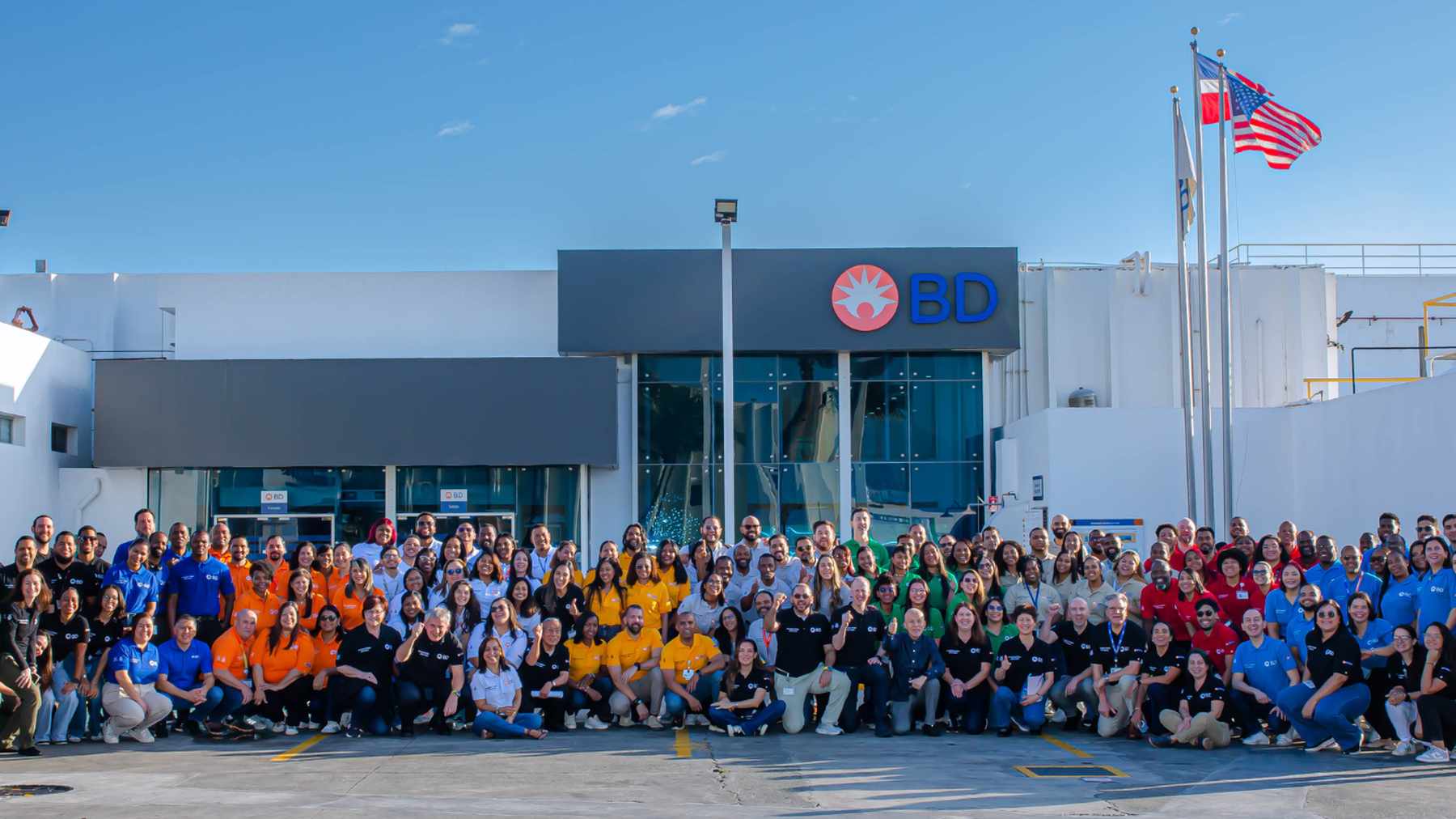 Well over a hundred smiling BD associates in team shirts gathered outside BD's plant in the Dominican Republic