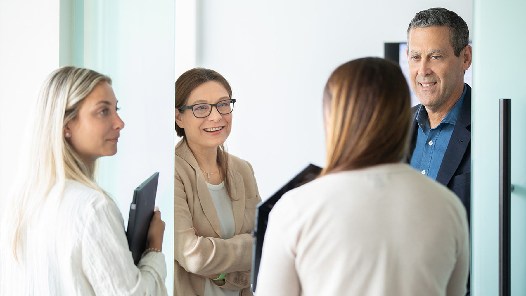 Four Bicara colleagues talking together in a bright office