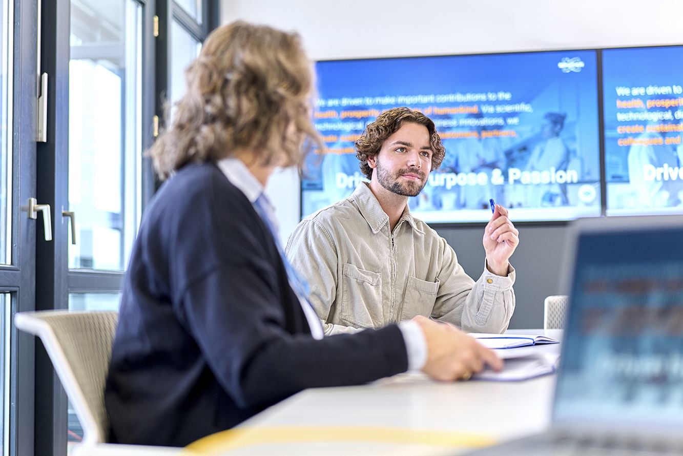 Bruker colleagues discussing their work at an office table