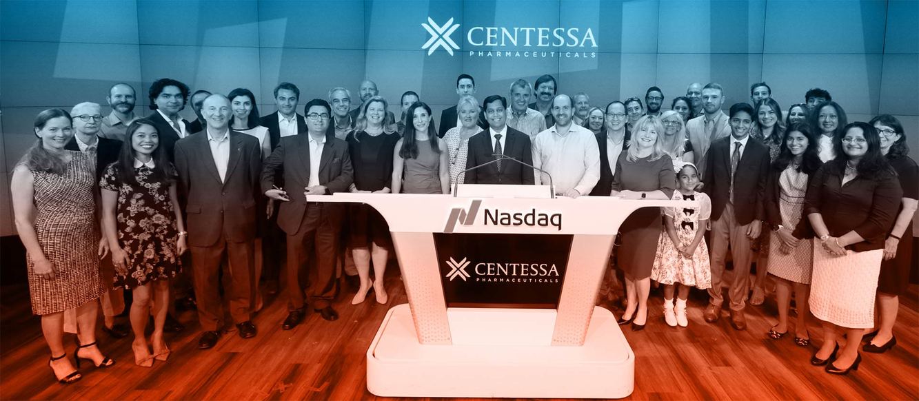 About forty Centessa Pharmaceuticals colleagues posed around a Nasdaq podium beneath the Centessa logo
