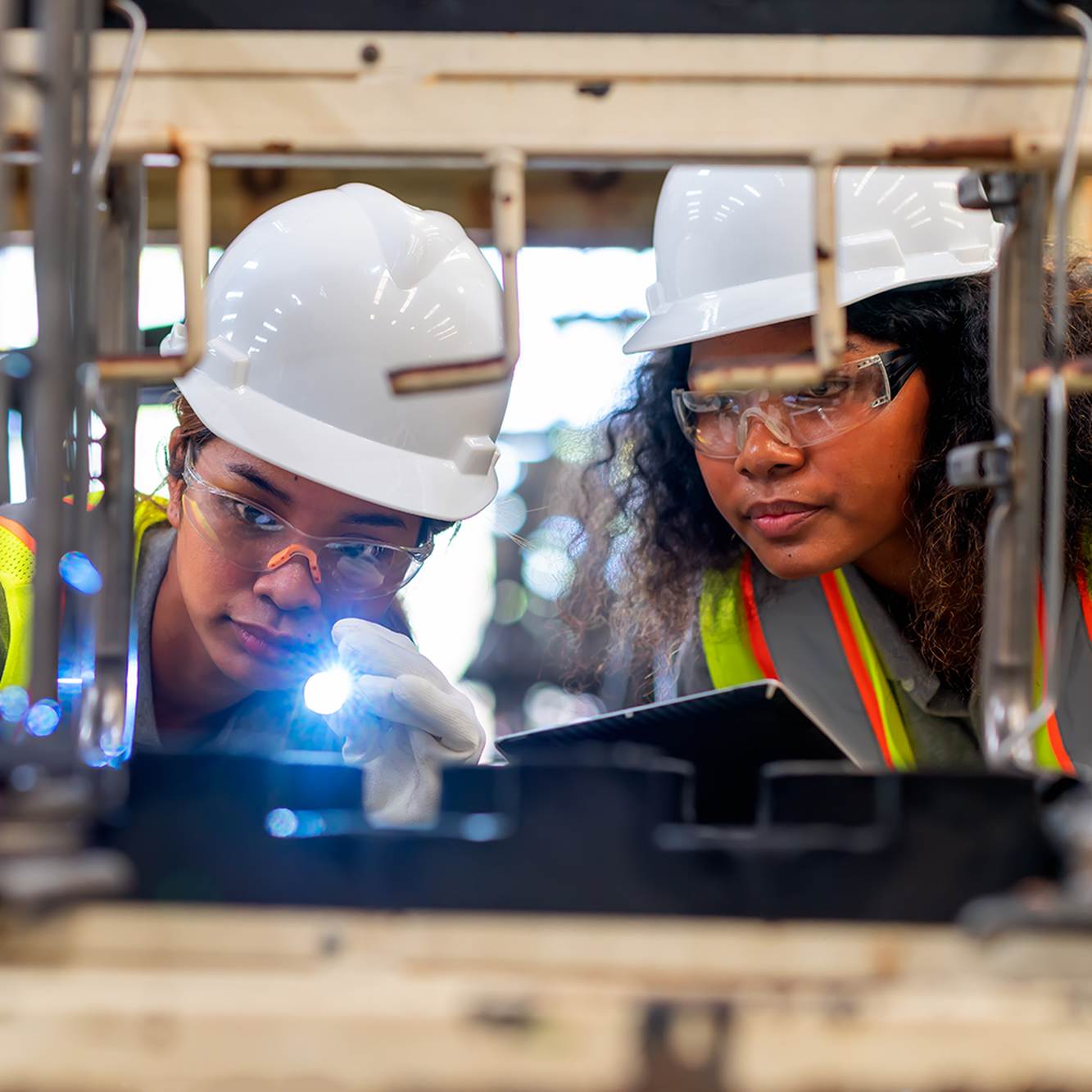 Two Convatec engineers inspecting equipment in a manufacturing facility