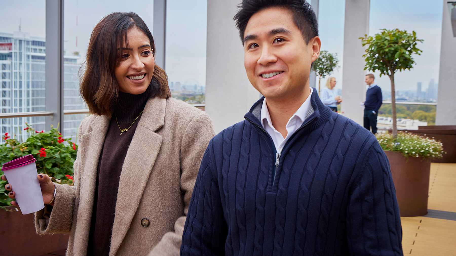 Two Convatec colleagues talking together on an office terrace