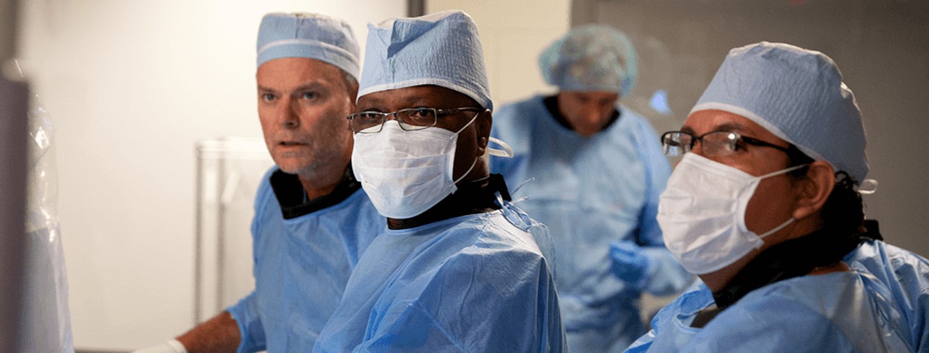 Cook Medical clinical collaborators discussing a procedure while wearing surgical clothing