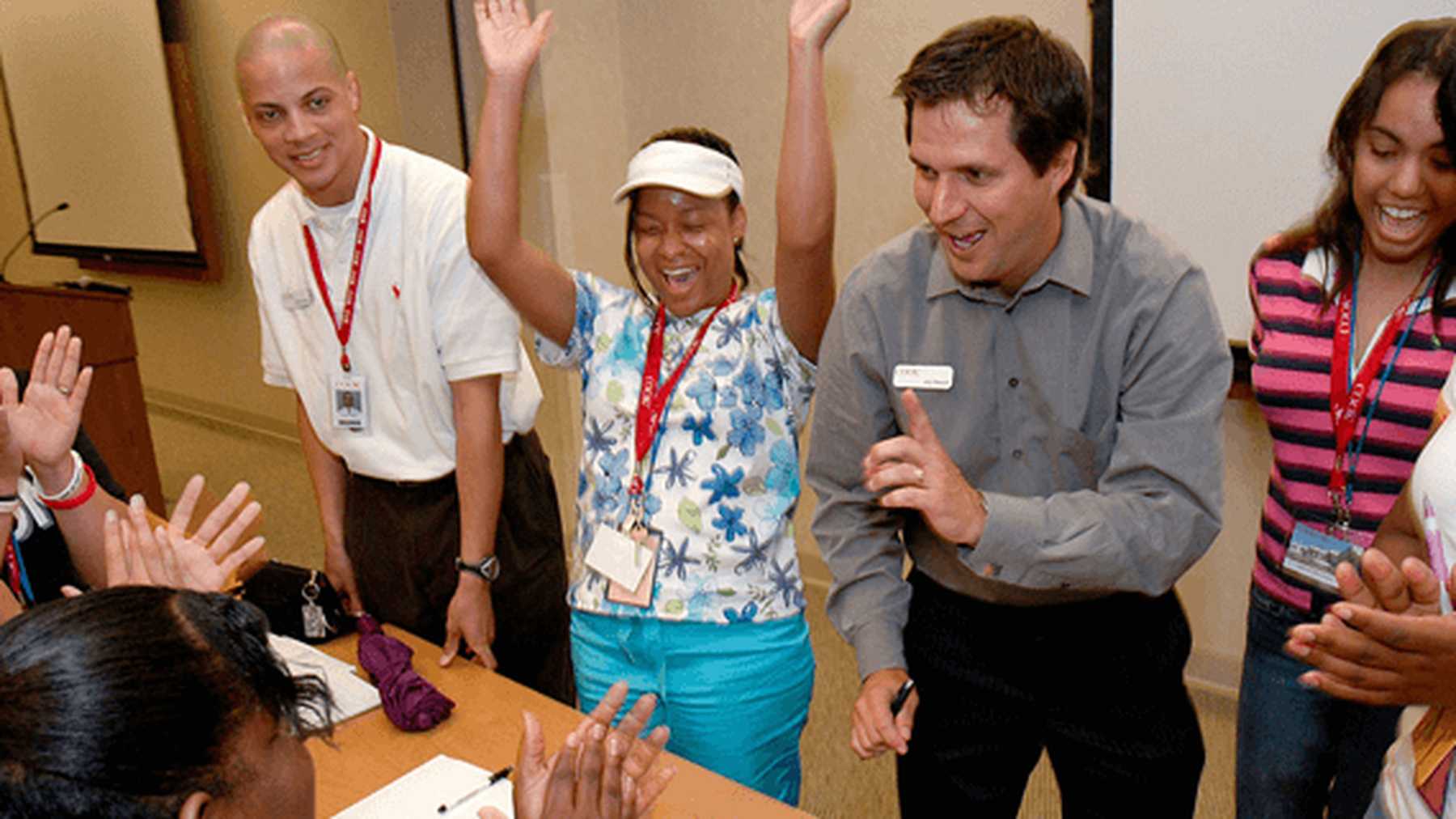 Cook Medical colleagues smiling and applauding together at an office celebration