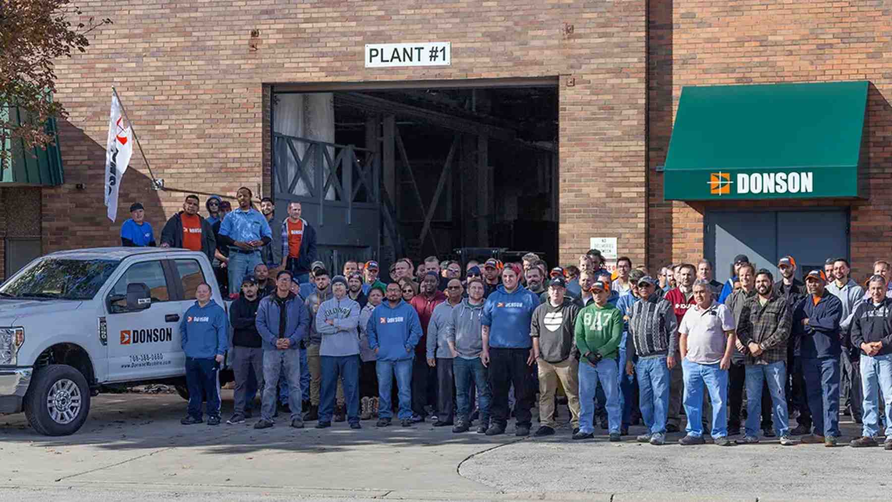Donson employees gathered outside the company’s manufacturing plant