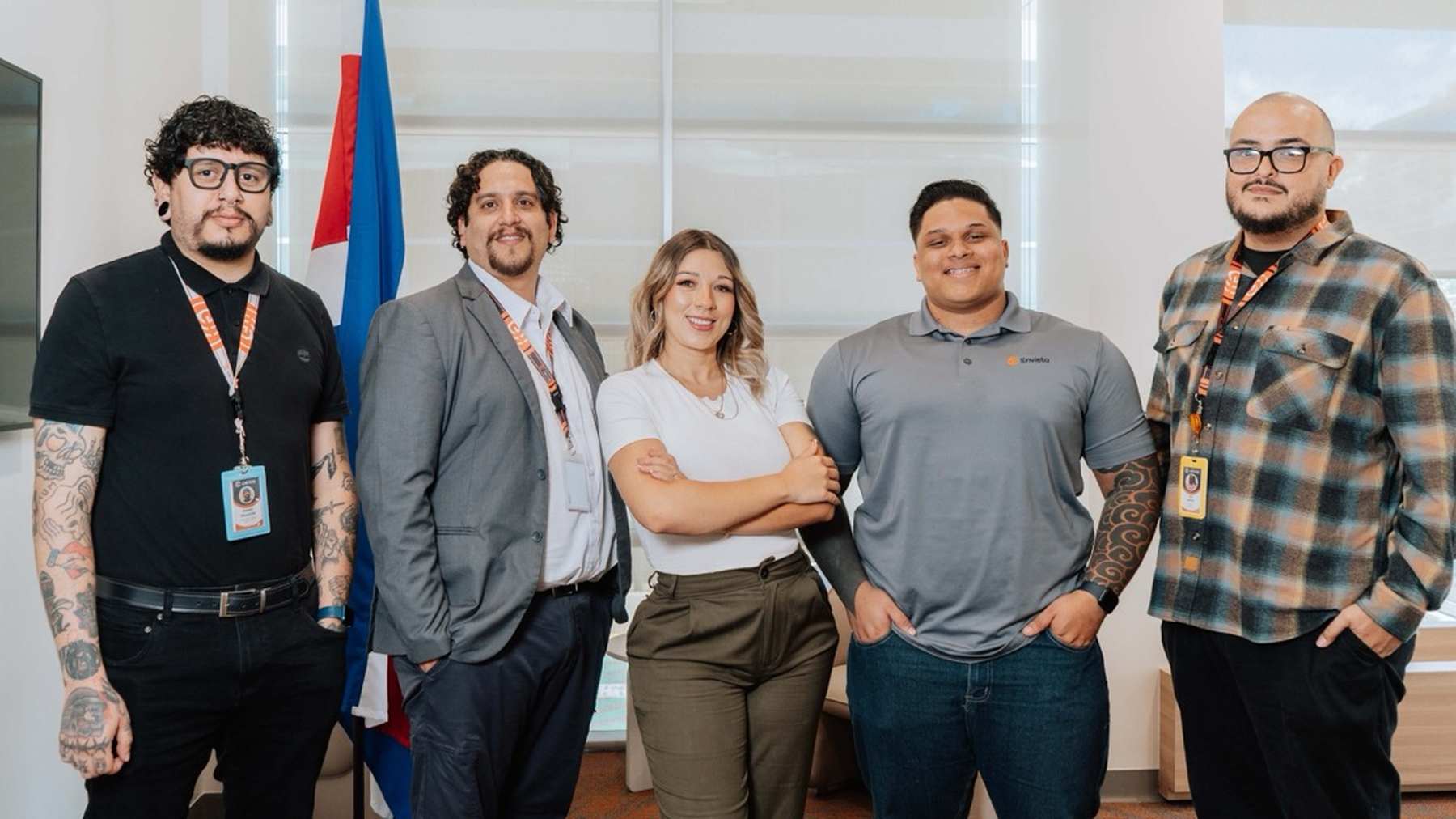 Five Envista colleagues standing together at work