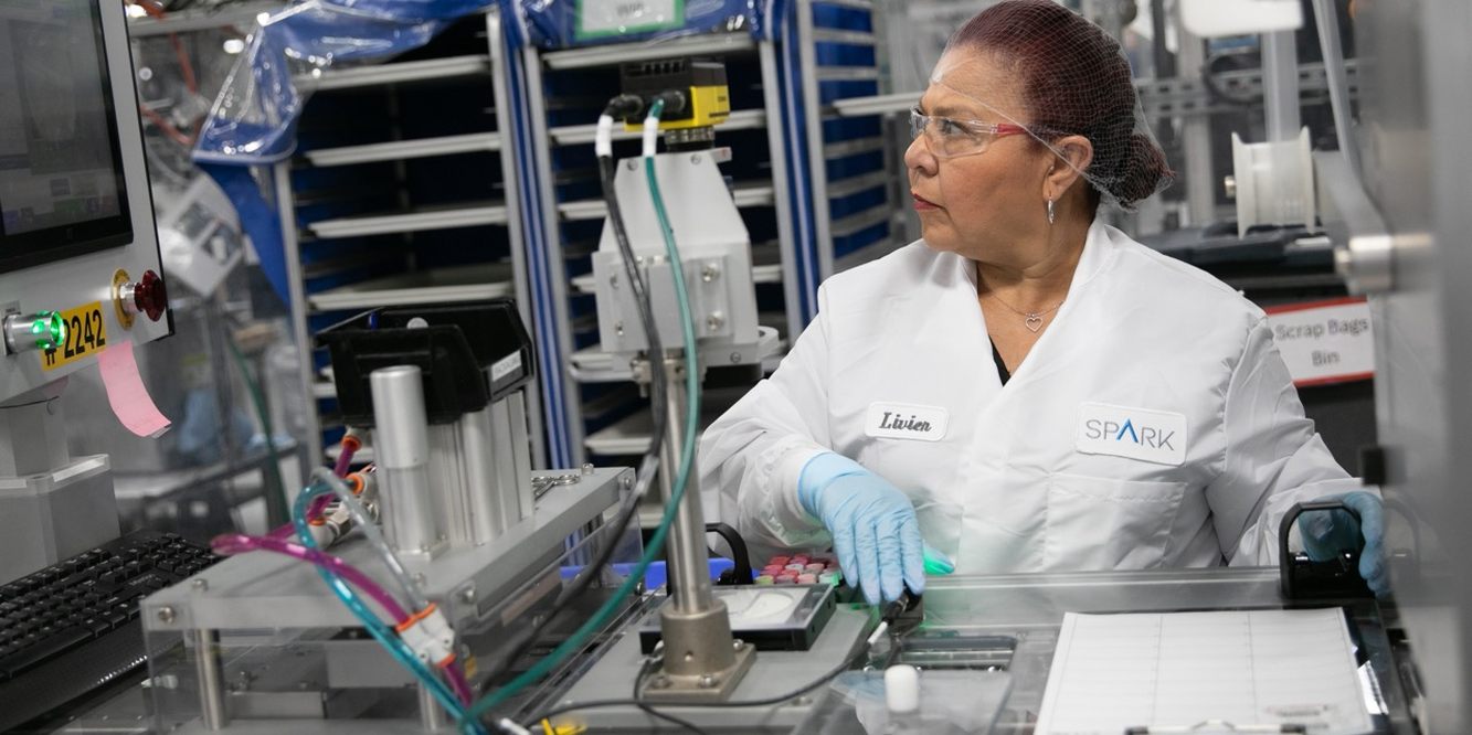 An Envista employee working on equipment in a manufacturing facility