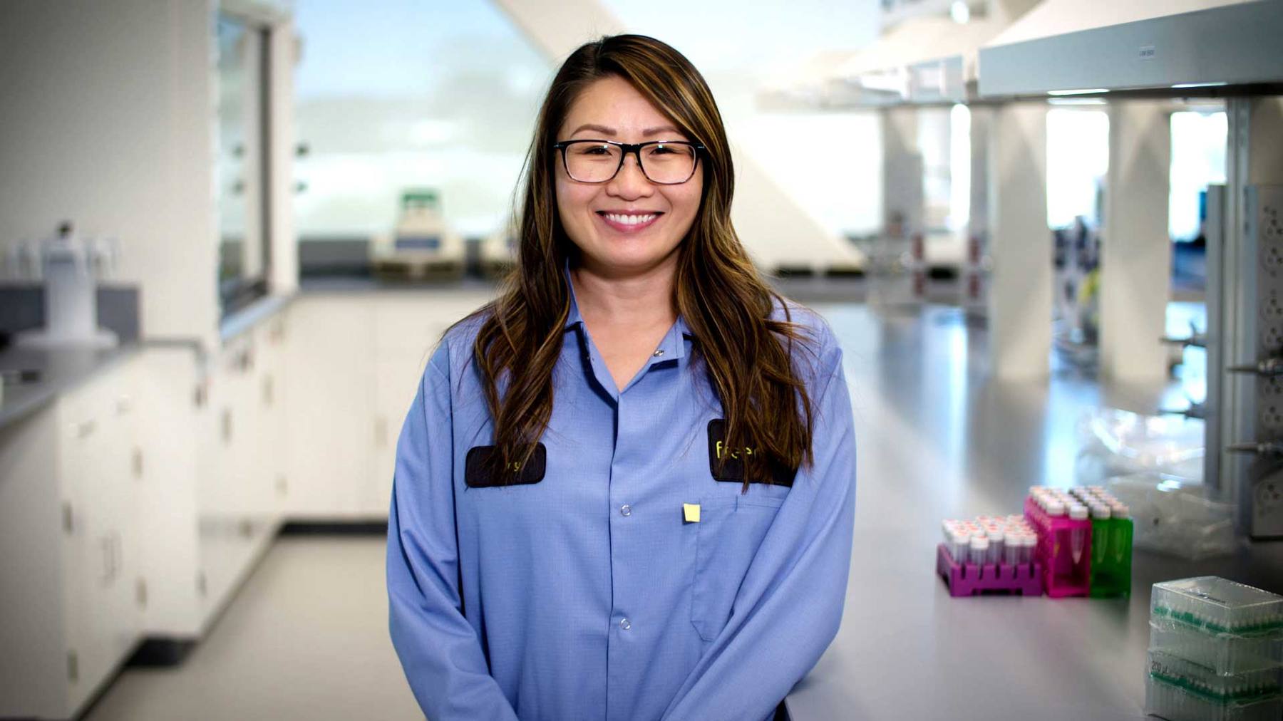 A smiling Freenome colleague pictured inside the company laboratory