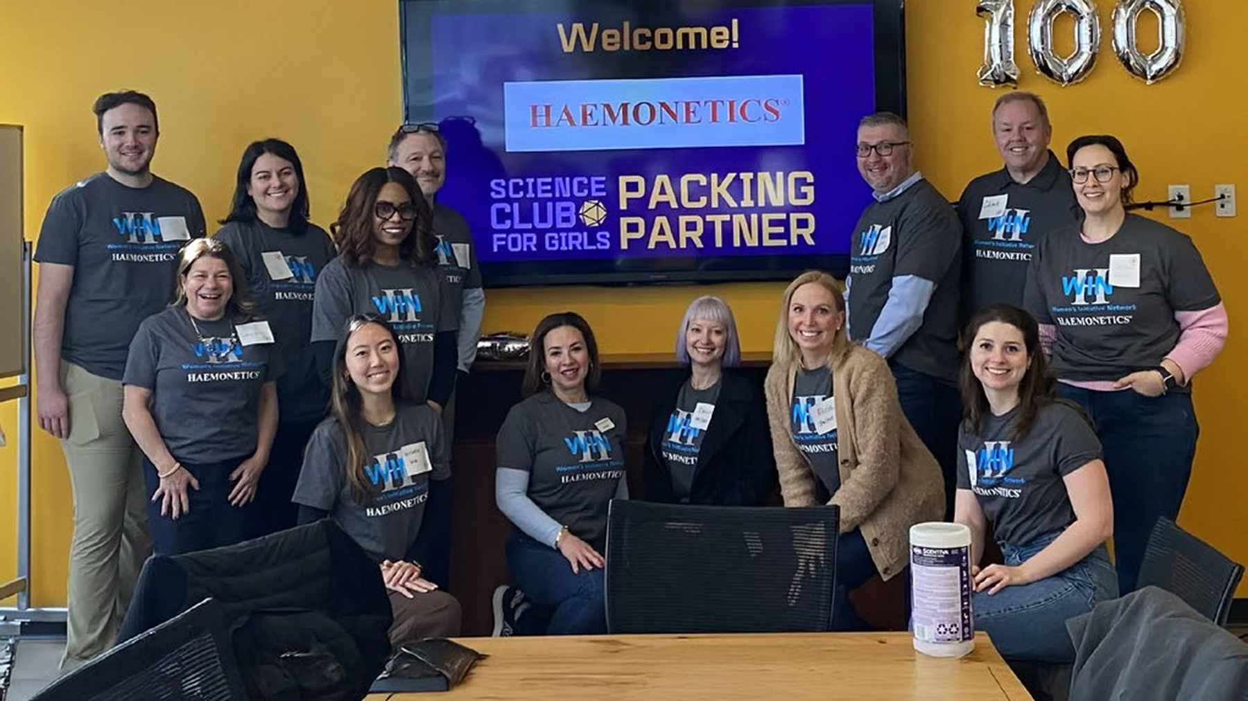 Haemonetics colleagues smiling together at a Science Club for Girls packing event