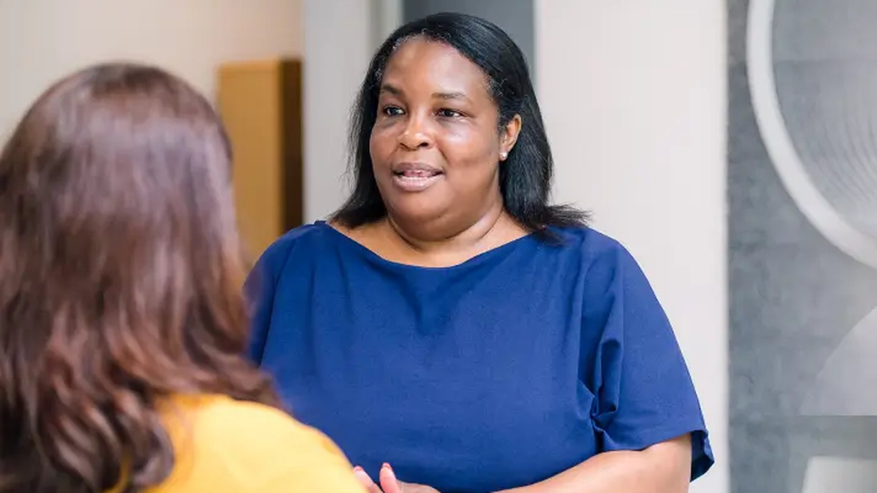 Two Highridge Medical colleagues talking together at work