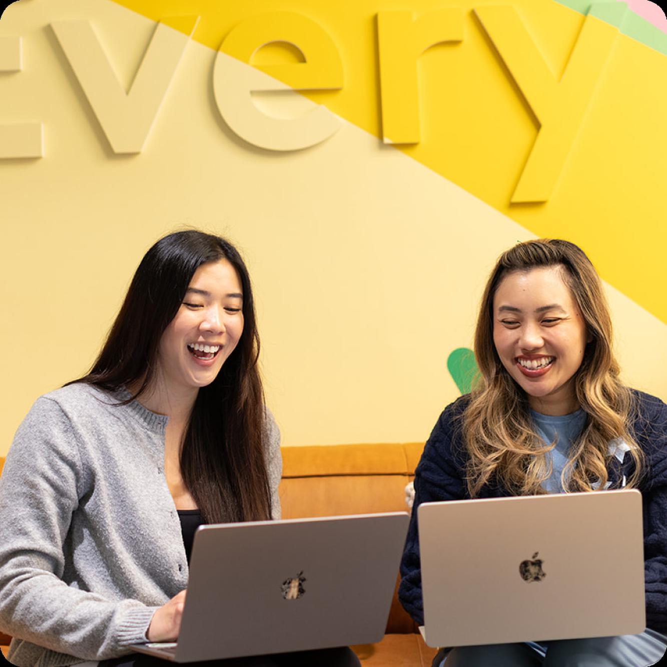 Two Hinge Health colleagues collaborating over a laptop
