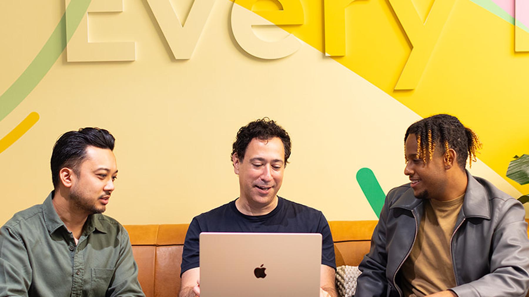 Three Hinge Health colleagues working together on a laptop