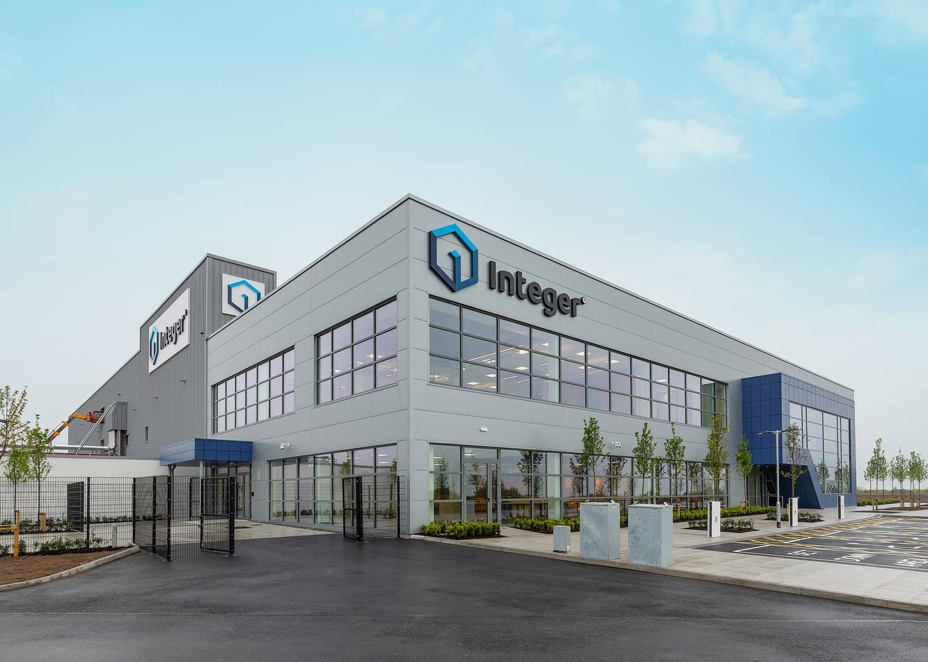 Integer's modern gray manufacturing facility in Galway, Ireland, with the Integer name on its facade