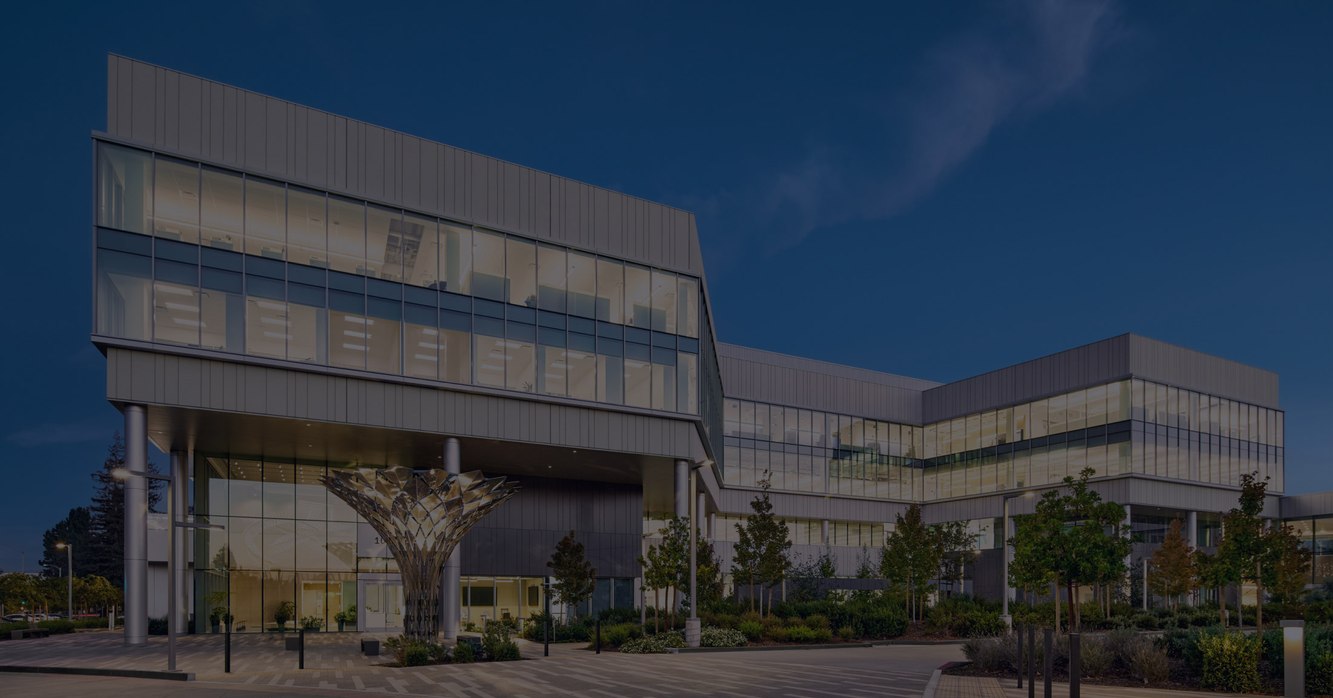 Intuitive's glass-fronted corporate headquarters building in Sunnyvale, California at dusk