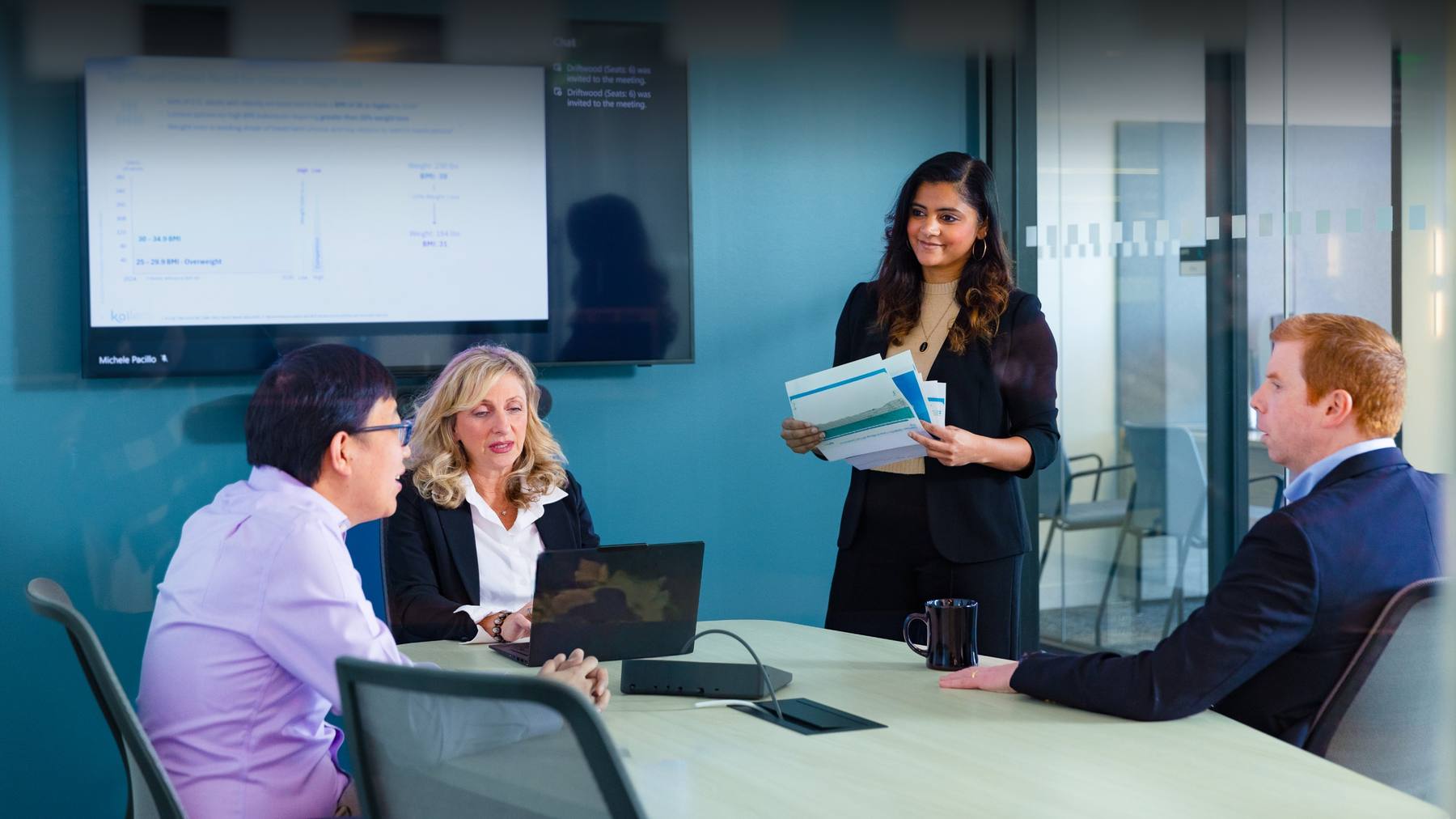 Four Kailera colleagues collaborating around a meeting table