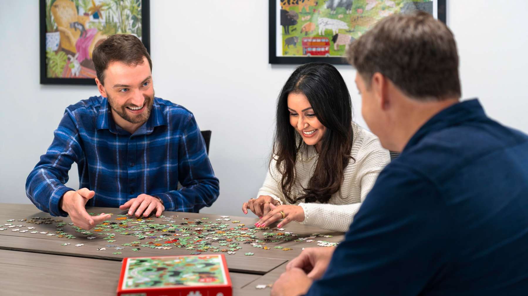 Three Kardigan colleagues working together on a puzzle