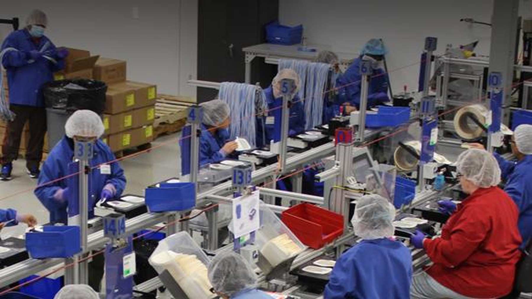 Katecho manufacturing colleagues working together on the medical device assembly floor