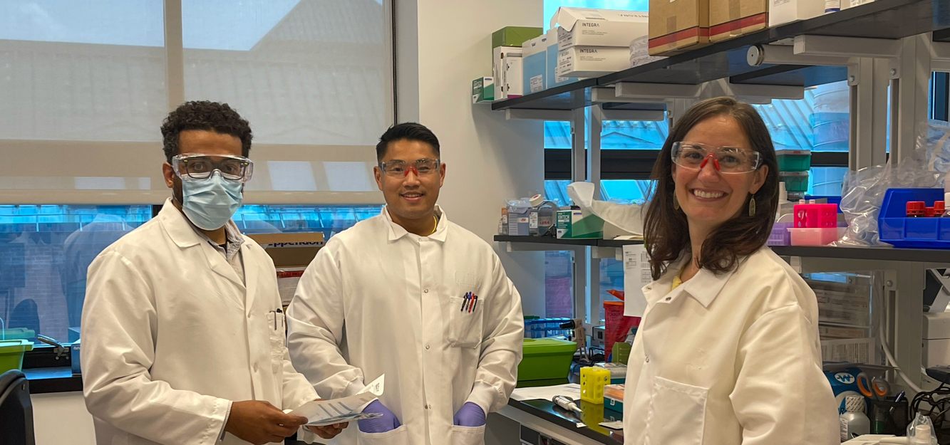 Three Korro Bio scientists together in a laboratory