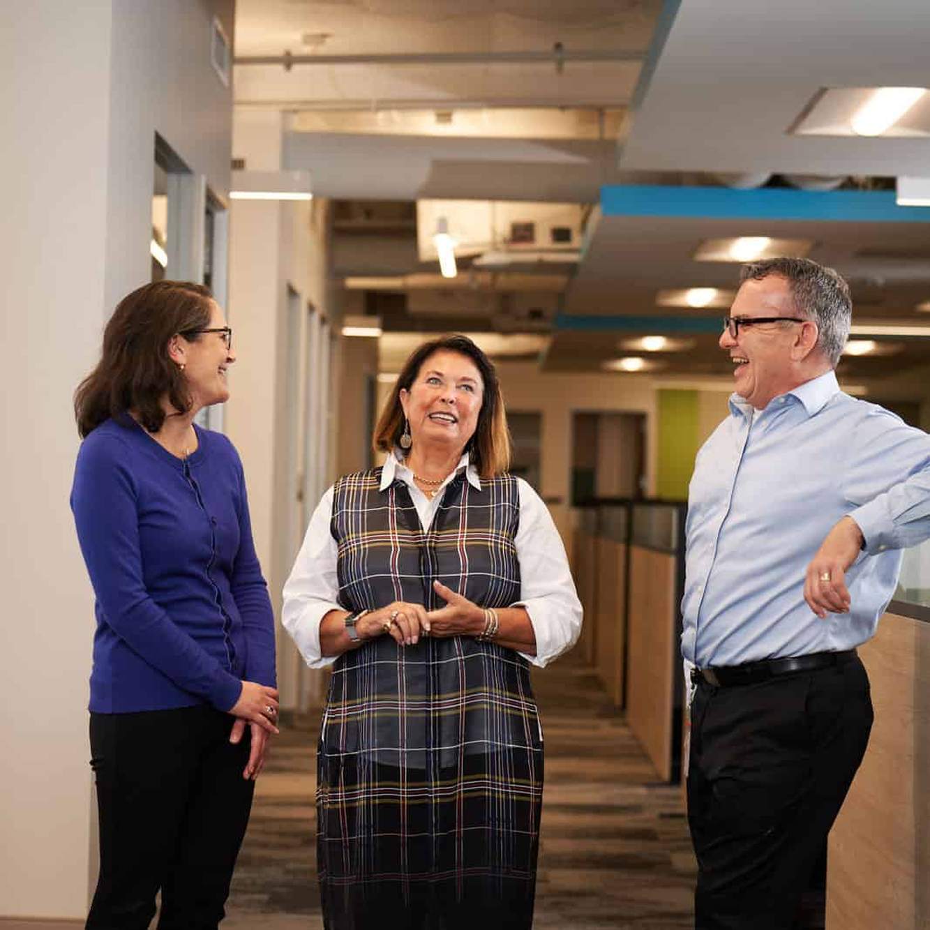 Kura Oncology colleagues talking together in a bright office corridor
