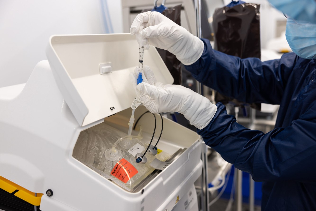 A Lyell employee working with equipment in the cell therapy laboratory
