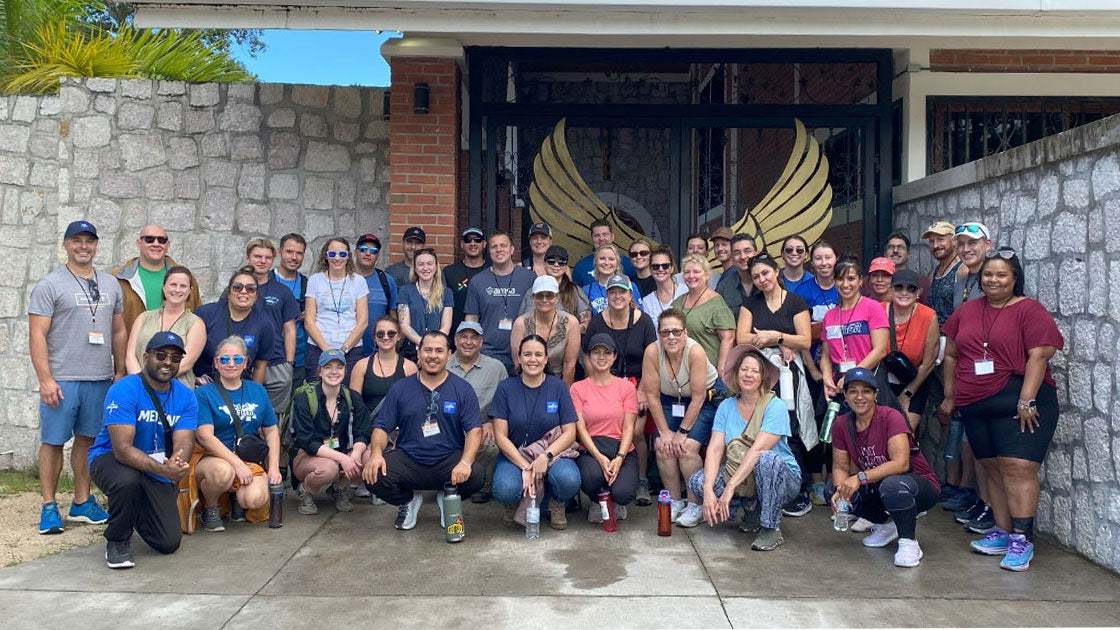About forty smiling Medline volunteers gathered for a group photo on a trip to Honduras