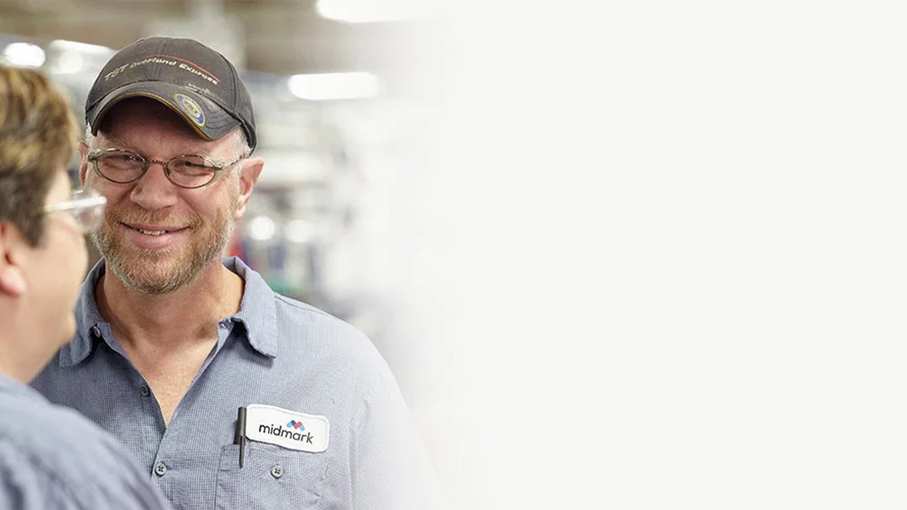 Midmark colleague smiling while speaking with another team member