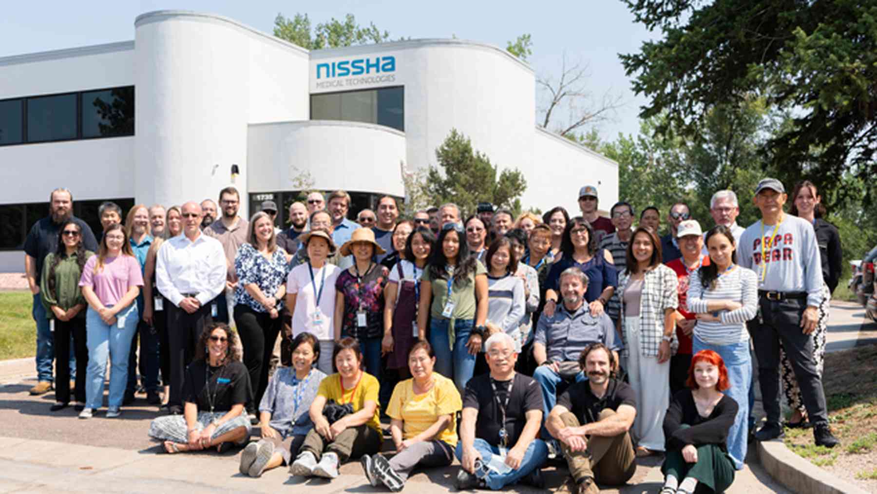 Nissha Medical Technologies colleagues gathered outside a company building