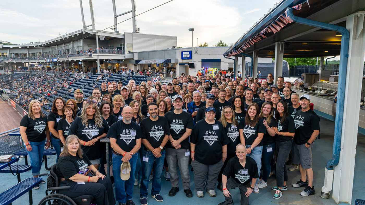 Pride Mobility employees gathered together at a ballpark