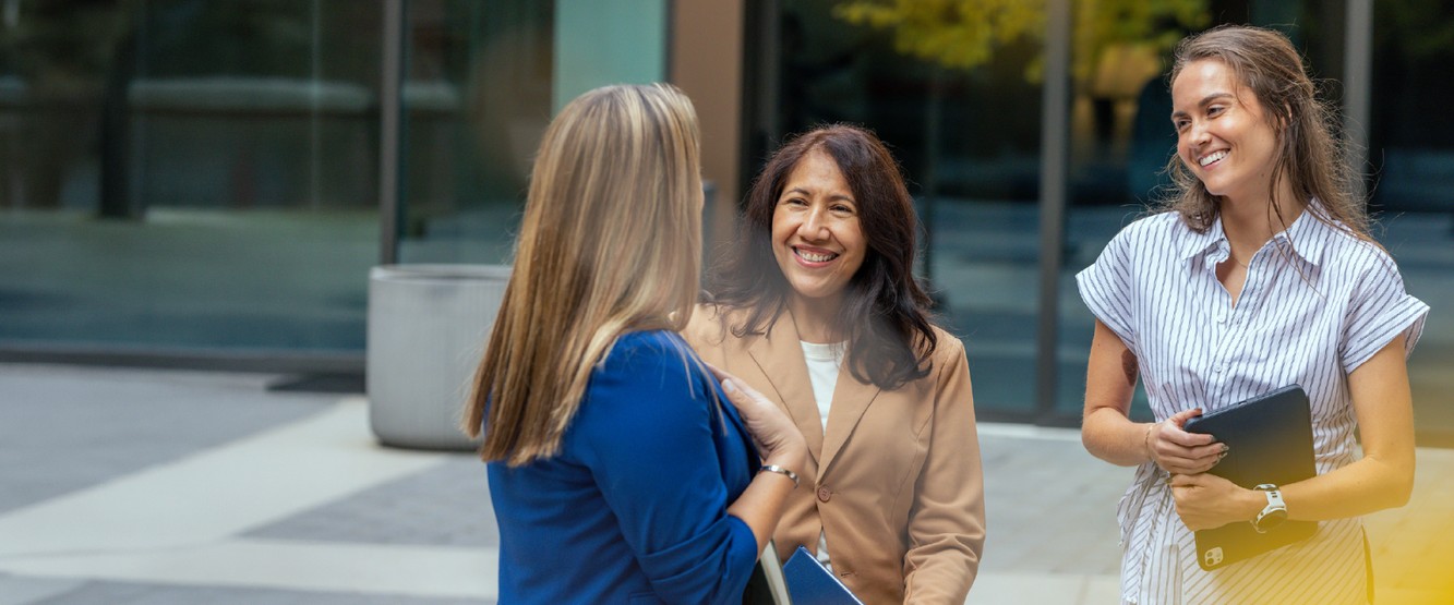 Three PTC Therapeutics patient engagement colleagues talking outside the workplace
