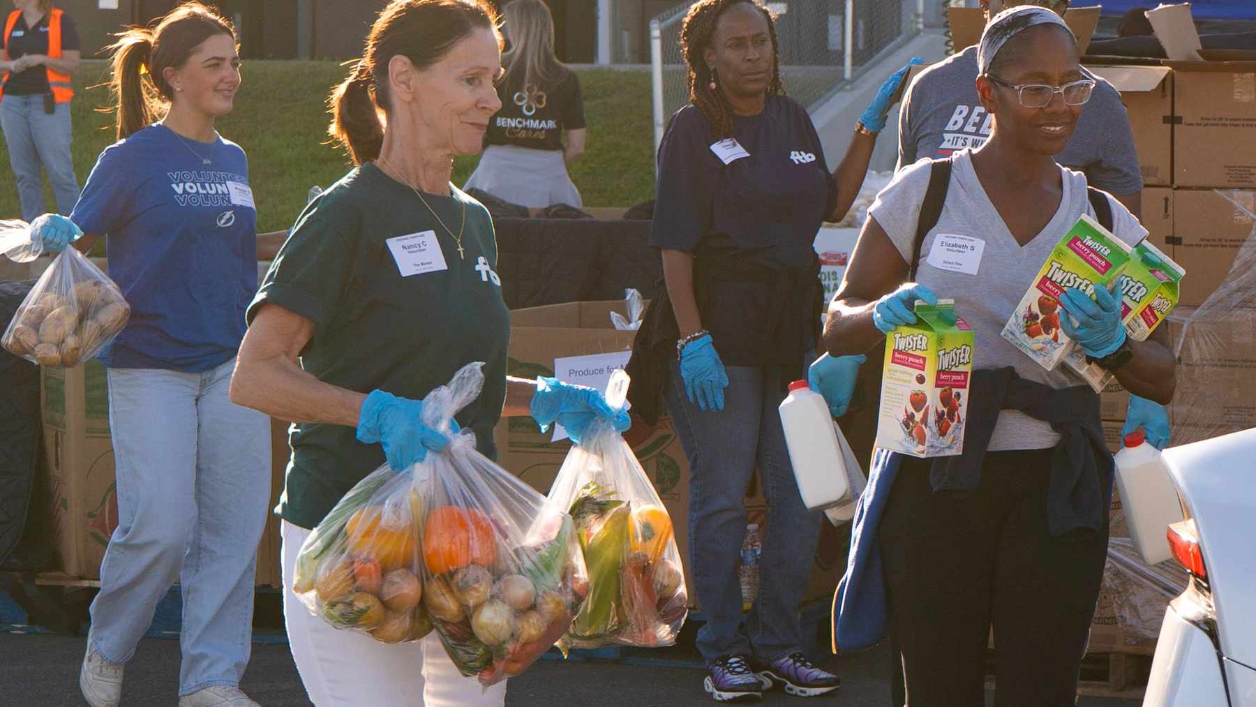 Quest Diagnostics volunteers distributing food together at a community event