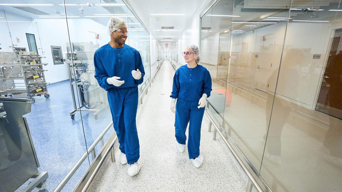 REGENXBIO manufacturing colleagues walking through the company’s production facility