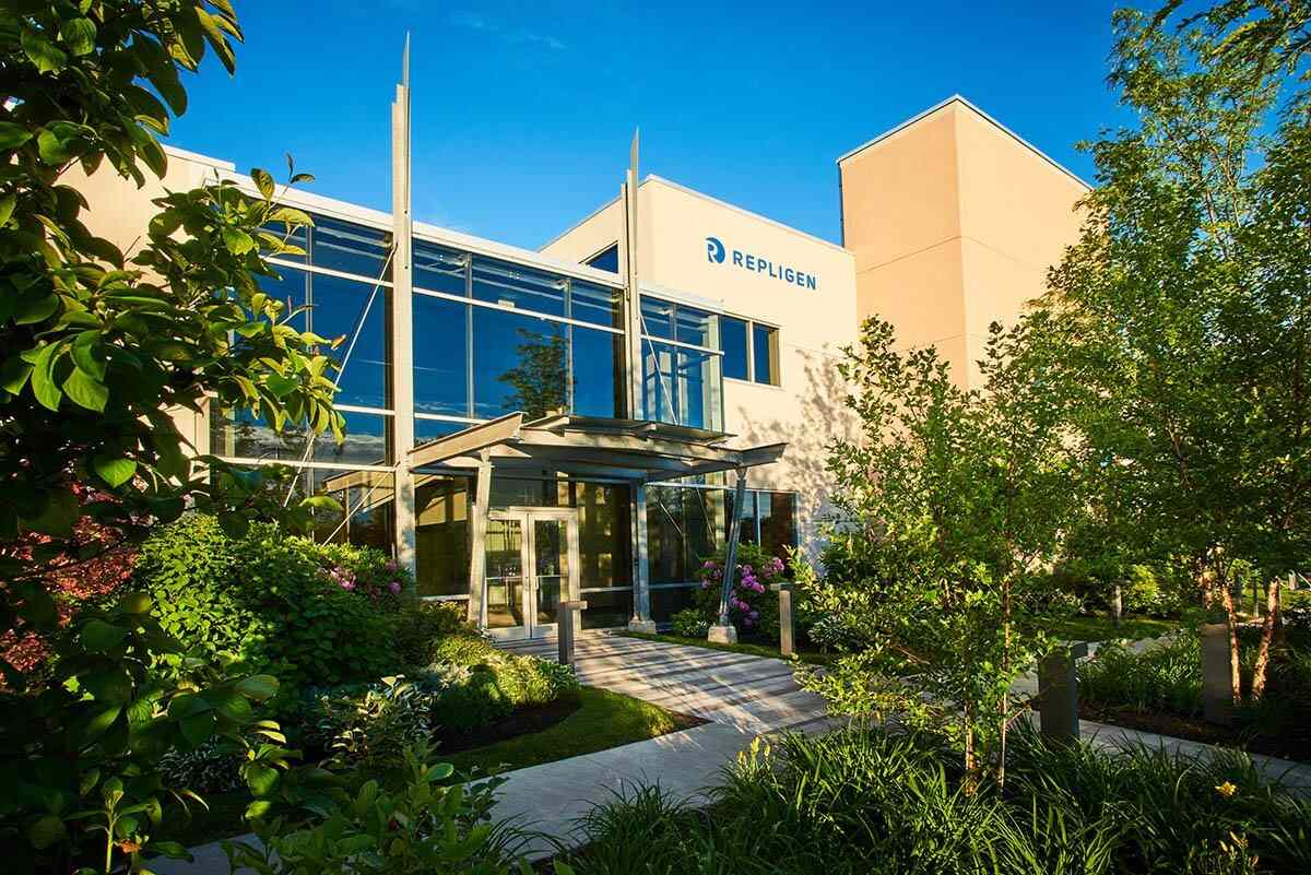 The entrance to a Repligen company facility surrounded by landscaping