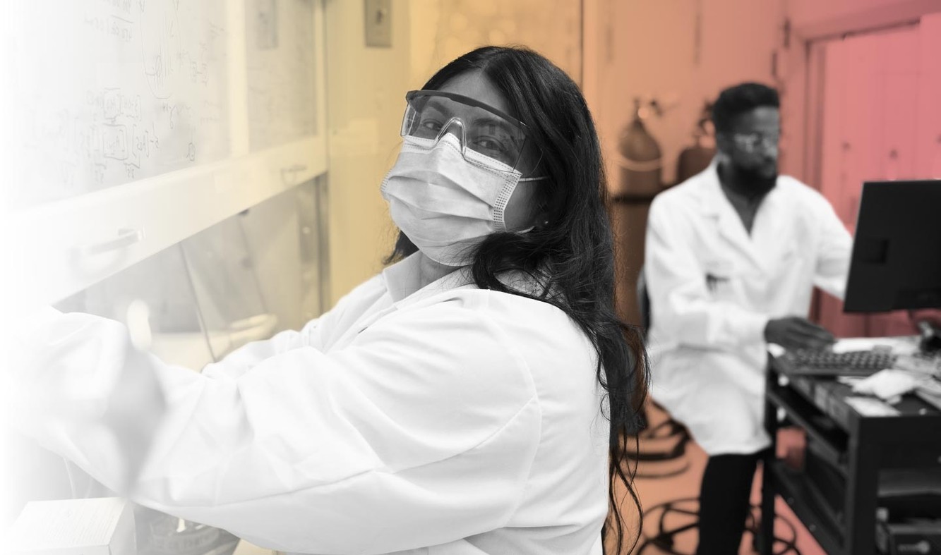 Stoke Therapeutics researchers collaborating at a laboratory workstation