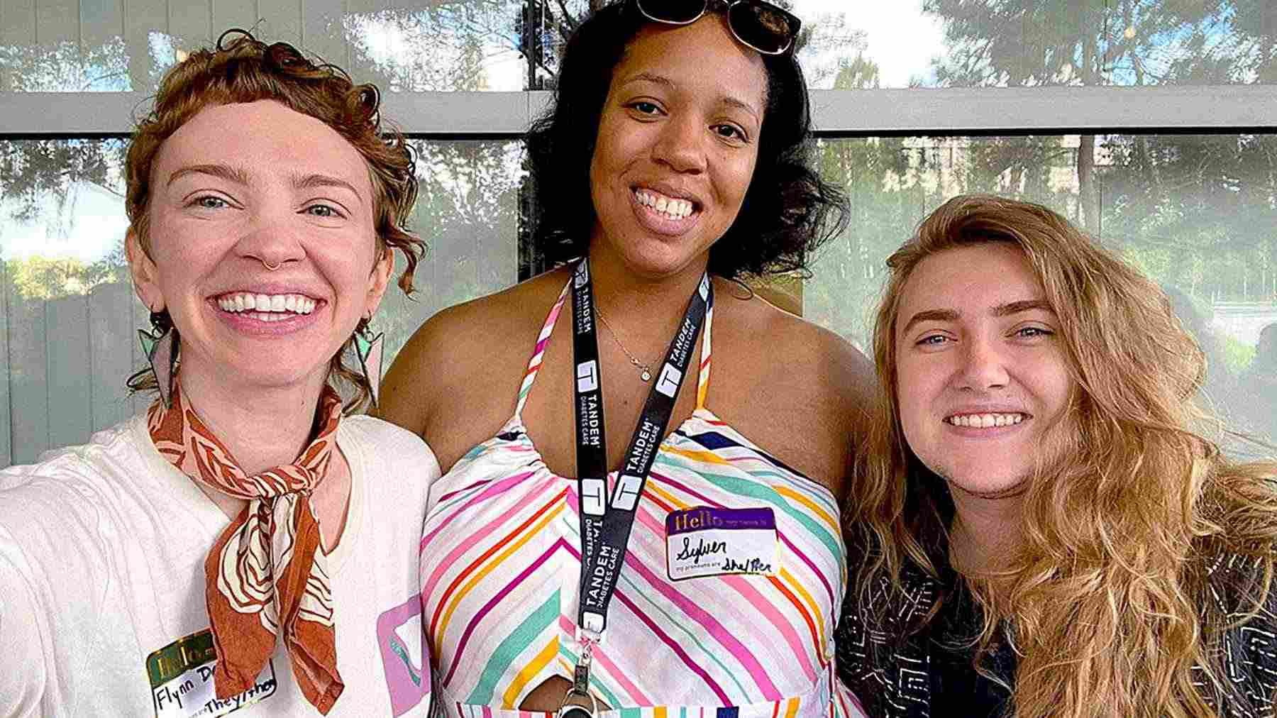 Three Tandem Diabetes Care employees speaking together at work