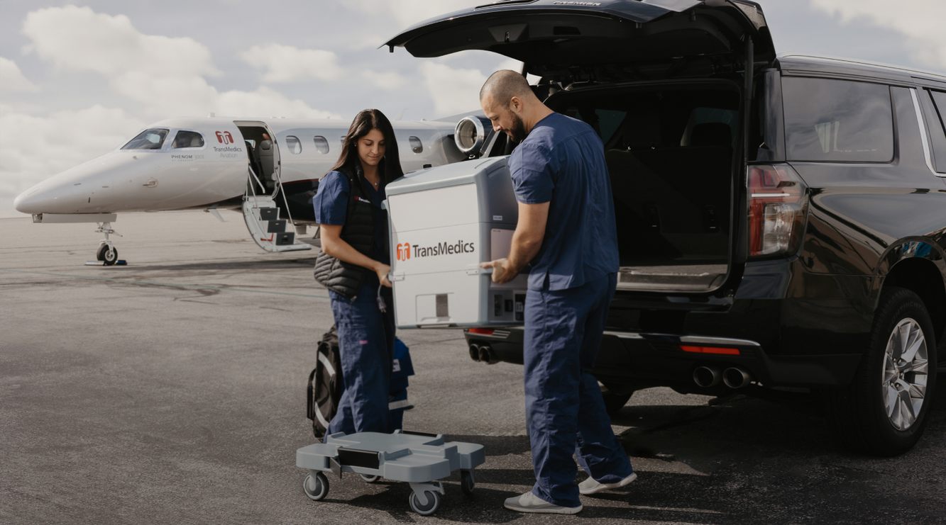 TransMedics colleagues loading an Organ Care System beside a company aircraft