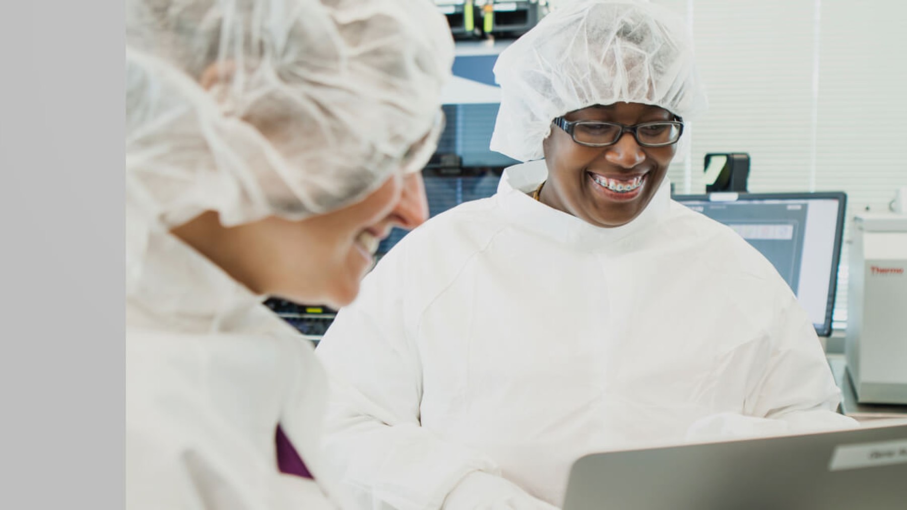 Twist Bioscience colleagues smiling together in protective laboratory clothing
