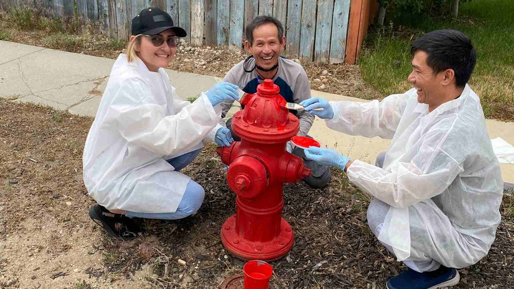 Ultradent colleagues painting a fire hydrant during a community volunteer activity